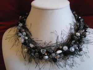 Eyelash yarn added to beads to create a striking necklace on Etsy